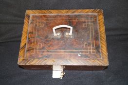 A wooden effect painted metal cash box with key