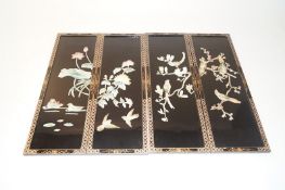Four oriental lacquer panels, each decorated with various scenes