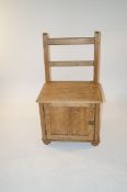 A pine seat with compartment to the base