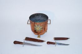 A large brass ice bucket and two Indian daggers