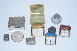 A Stratton mother of pearl compact along with a collection of travel clocks and trinket boxes