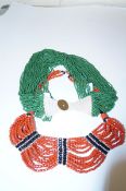 Two ethnic type multi-bead necklaces, orange and green