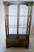 A carved wooden oriental display shelving unit