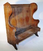 An oak Robert "Mouseman" Thompson apprentice settle, with a carved frog to the top left hand side