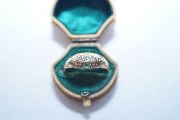 A ladies ring with five central stones diamonds, Stamped "18ct"