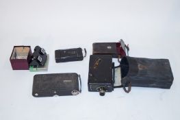 Two Kodak cameras and another camera
