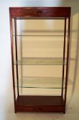 A large oriental hardwood cabinet with glass shelves