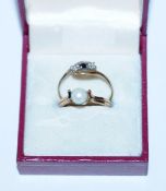 Two rings in a box, 19ct with CZ stones, 1 filled Gold with Pearl