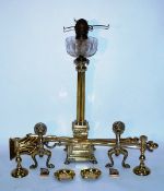 A large brass lamp stand in the form of Nelson's column along with brass candle sticks, fire dogs