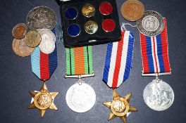 A collection of WWII medals and various coins