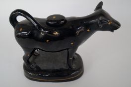 A 19th century black and gold ceramic cow creamer