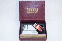 A boxed Minicine camera set along with nine still films including four Enid Blyton