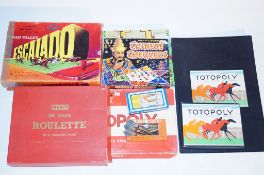 A collection of board games including, Monopoly, Totopoly, Escalado and others