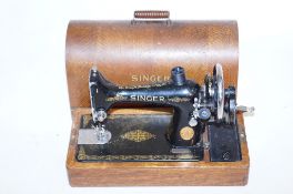 A vintage Singer sewing machine t/w mat and instruction book