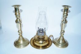 A brass oil lamp and a pair of brass candle sticks