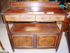 An Edwardian sideboard with central lower shelf, and two lower cupboards