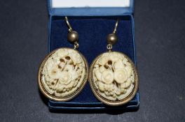 Pair of antique carved earrings