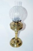 A brass oil lamp and shade