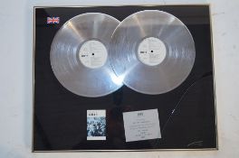 A framed presentation disc of UB40 awarded to DEP International for more than 600,00 sales,