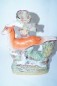 A 19th Staffordshire figure of a deer with hunting dogs chasding