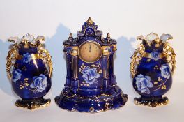 A three piece ceramic clock garniture