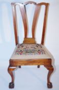 A mahogany dining chair on ball and claw feet