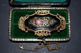 A fine Edwardian brooch decorated with flowers and a blackstone, probably gold