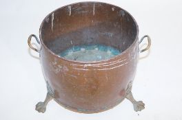 A copper pot on claw feet