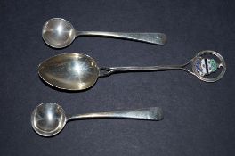 Two silver mustard spoons and another spoon