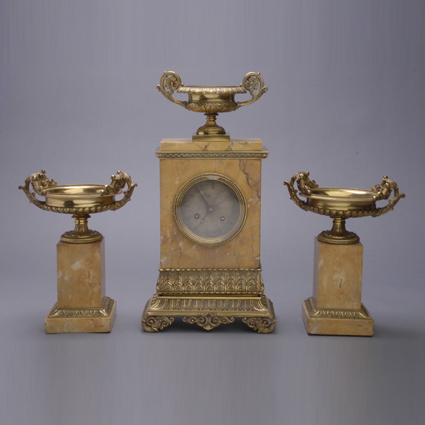 Napoleon III Gilt Bronze Marble Clock Garniture, the Sienna marble specimen mounted edifice form