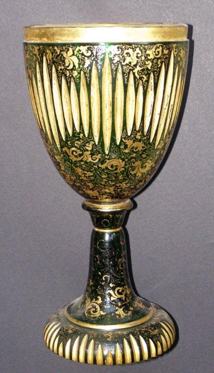 A 19thC Bohemian gilded green glass goblet vase decorated in vertical cuts, 11" high - some rubbing