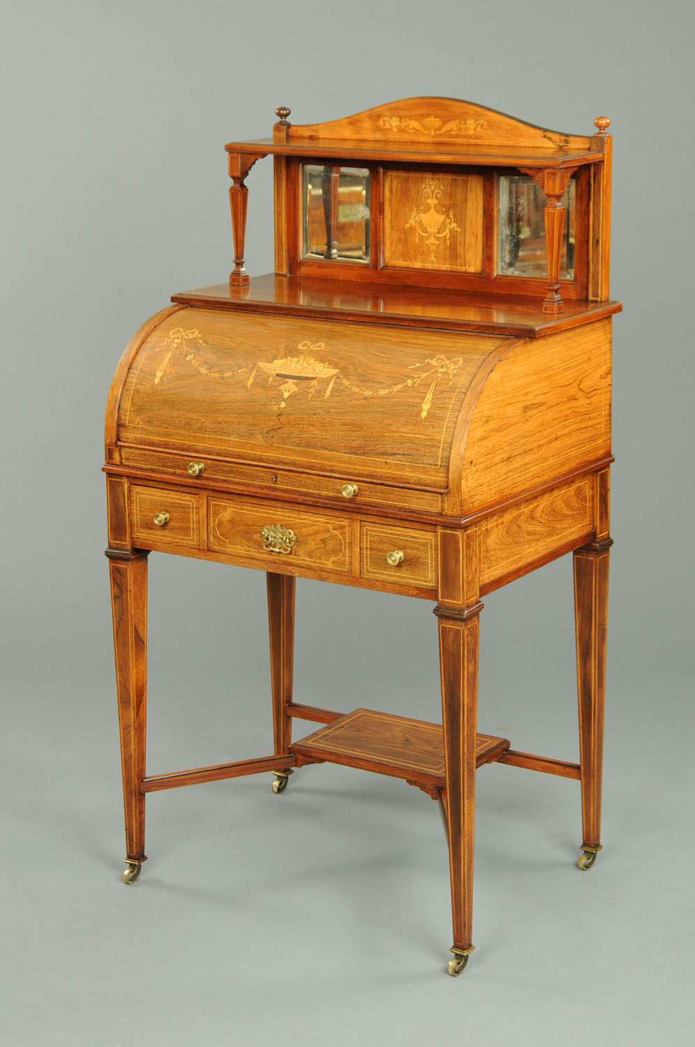 An Edwardian inlaid mahogany cylinder desk, with rear upstand above the cylinder bureau, with