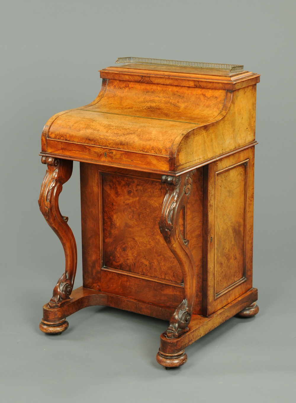 A Victorian walnut Davenport desk, with rise and fall stationery cabinet, piano front and sliding