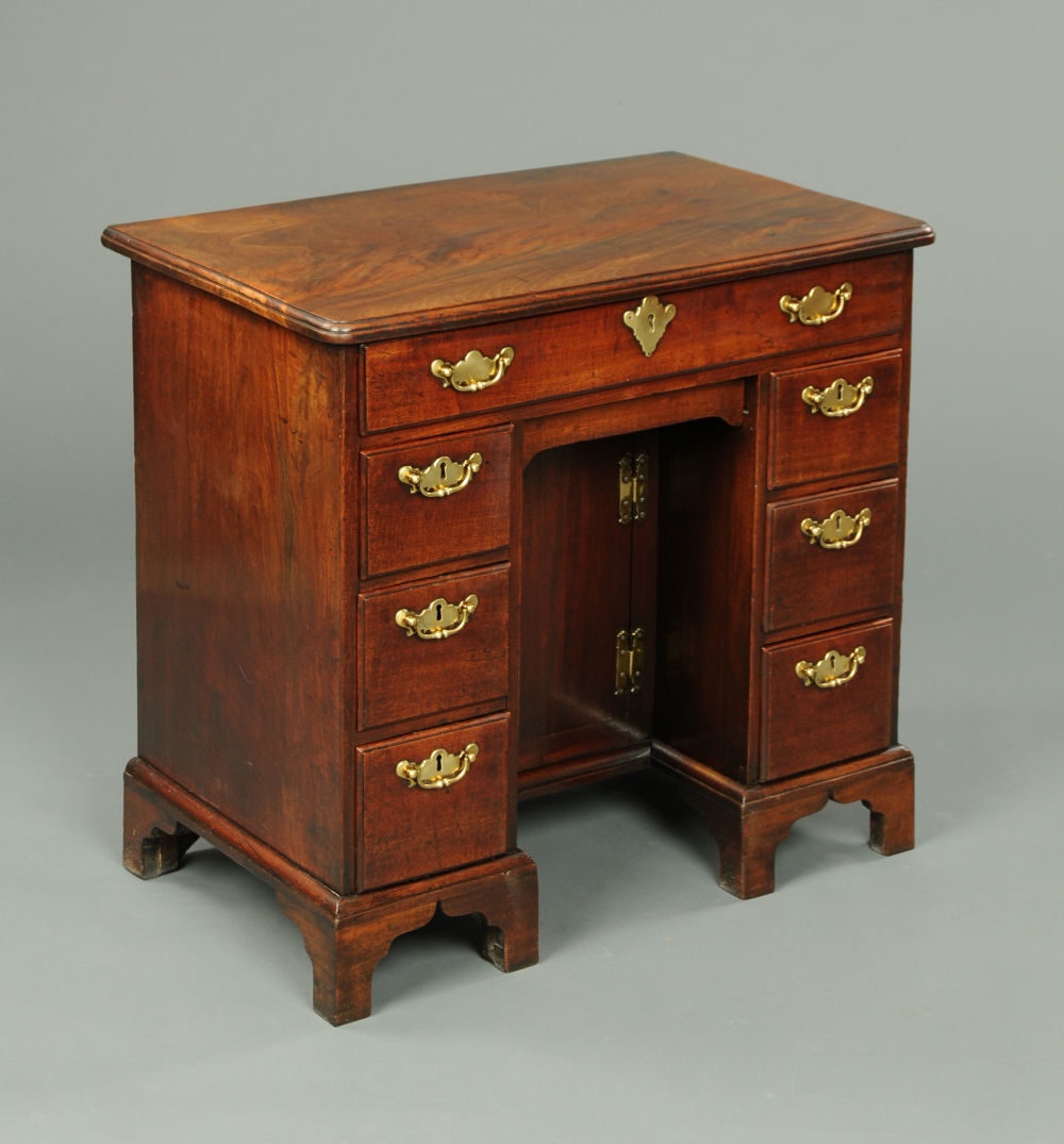 A George III mahogany kneehole desk, well figured, with moulded edge above a frieze drawer, recessed