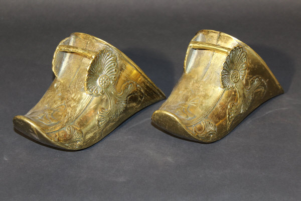 A pair of 19th century Spanish or South American brass stirrups with ornate scrolling floral