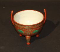 A Chinese pottery twin-handle three footed bowl decorated in seaweed green on a manganese / iron red