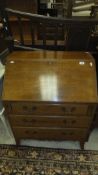 A mahogany bureau, the fall front over three drawers to spade feet