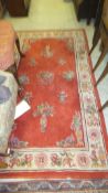 A Chinese Superwash rug with red ground, 218 x 123 cm