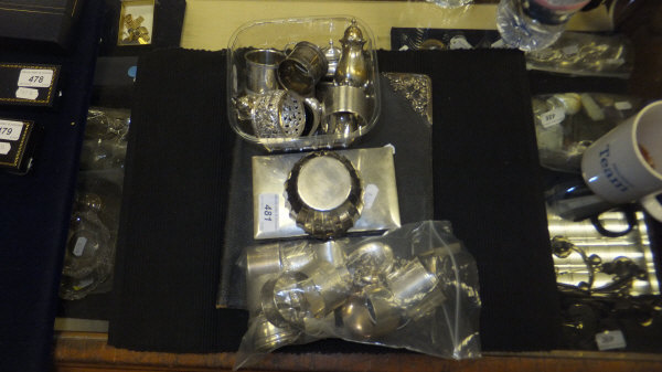 A bag containing twelve various silver napkin rings, together with a silver mounted cut glass