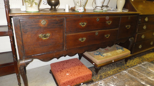 A circa 1800 oak dresser, the top with moulded edge above two drawers and two cupboard doors above a