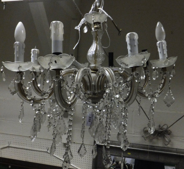A crystal cut glass eight branch chandelier with circular drip pans and pendant drops