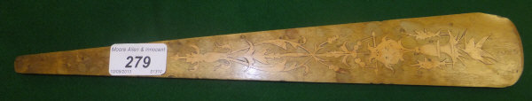 A maple and satinwood inlaid busque depicting a bird above an imp like mask and acanthus decoration