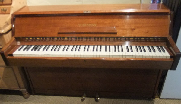 A modern mahogany cased upright piano, the iron framed over strung movement by Schumann