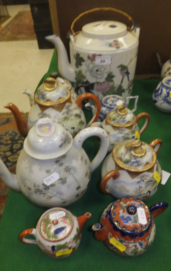 A 20th Century Japanese three piece tea set painted with Oriental figures with red and gilt