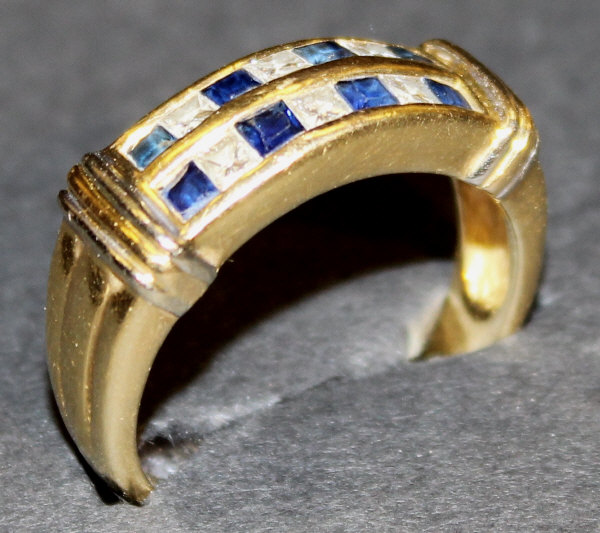 A 14 carat gold dress ring set with two rows of square cut sapphires and diamonds, each with four