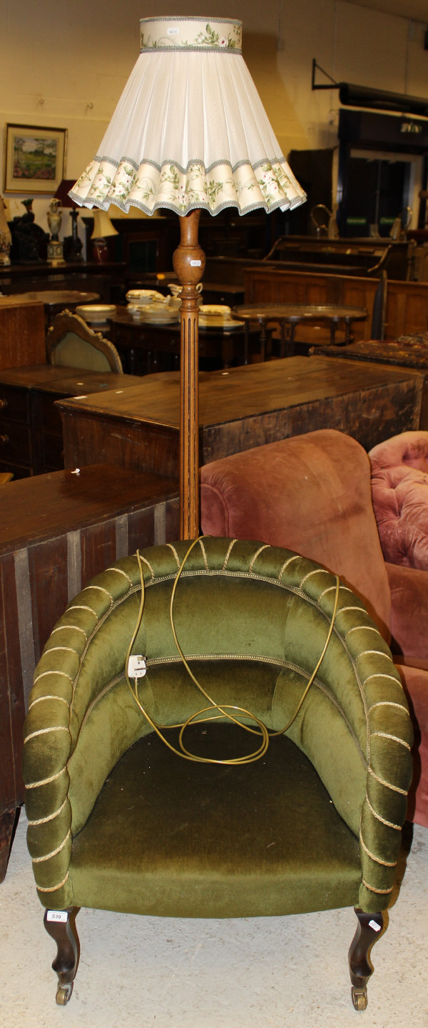 A circa 1900 upholstered salon tub chair with cabriole front legs to castors with green velvet