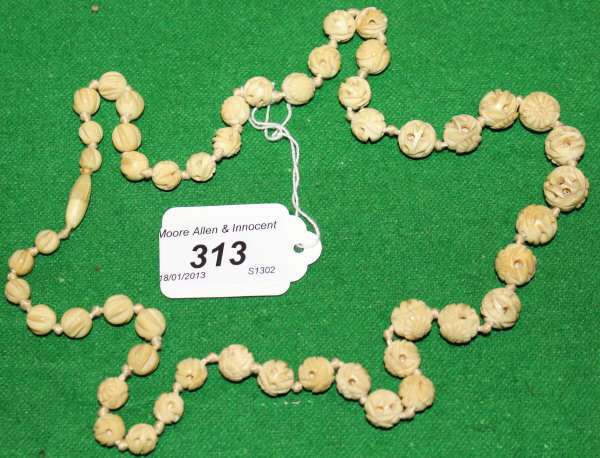 An early 20th Century carved ivory beaded necklace