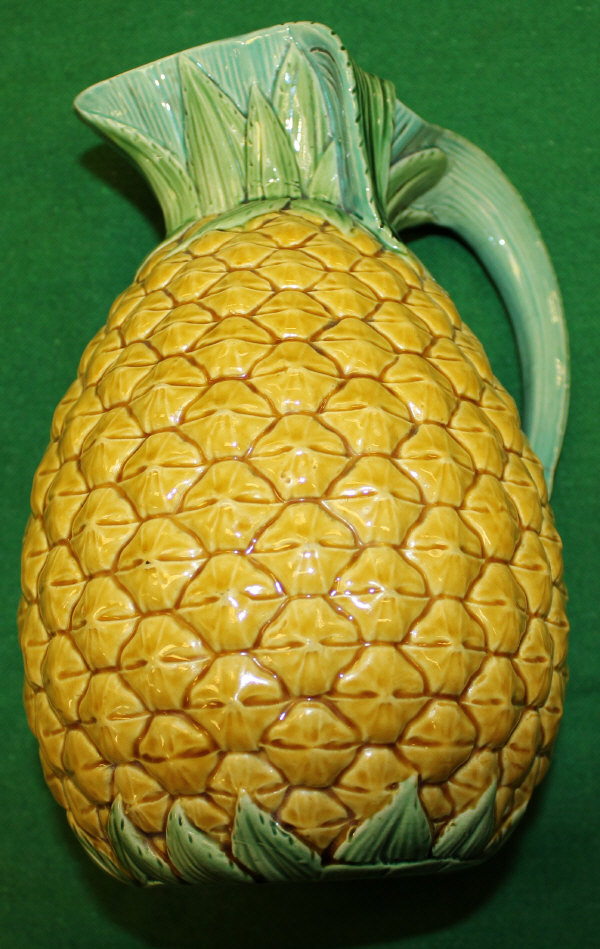 A 19th Century Minton pottery pineapple jug with leaf moulded decoration, in yellow and green glaze,