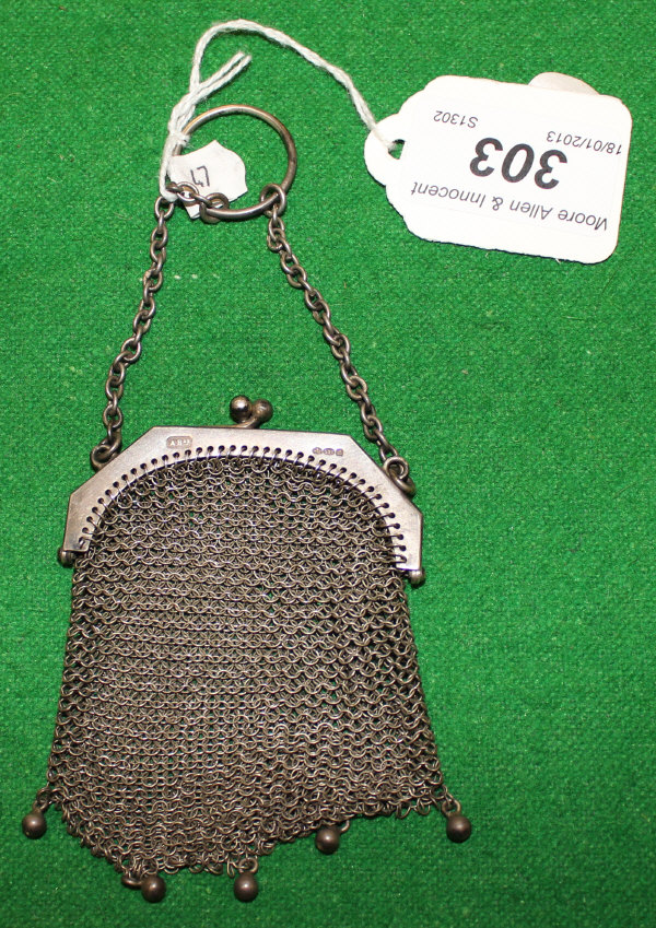 A silver mesh purse bearing import marks