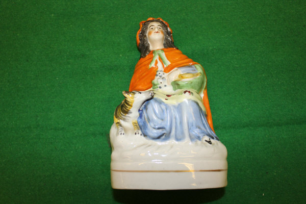 A 19th Century Staffordshire pottery figure of "Little Red Riding Hood", on a gilt-lined oval base